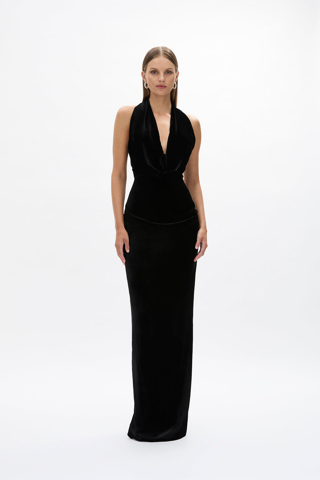 Front image of model wearing Rachel Gilbert Martin Plunge Gown, black velvet halter gown with deep plunge neckline and internal corset.