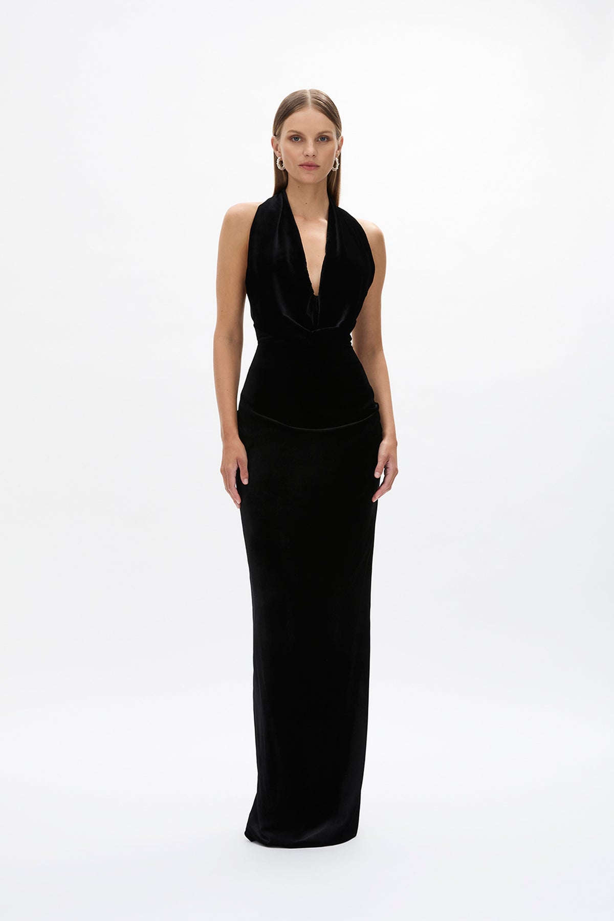 Front image of model wearing Rachel Gilbert Martin Plunge Gown, black velvet halter gown with deep plunge neckline and internal corset.